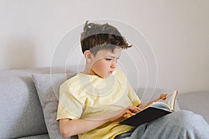 Boy reading an interesting book