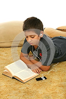 Boy reading and listening musi