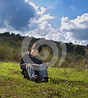 Boy reading outdoor