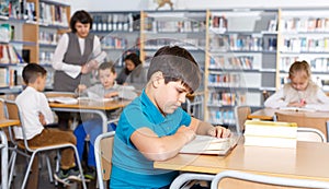 Boy reading in school library
