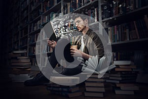 Boy reads a book in a library. Concept of curiosity, imagination and culture