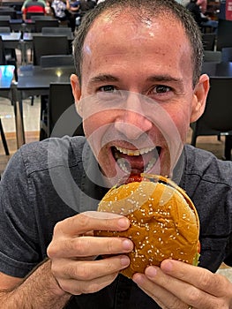 Boy ready to enjoy a delicious hamburger. photo