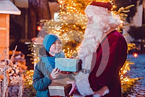 Boy receives a present from Santa Claus himself