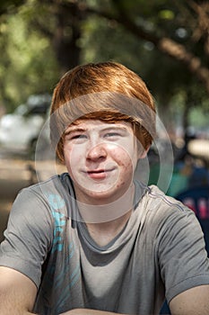 Boy with red hair and pickax in the face