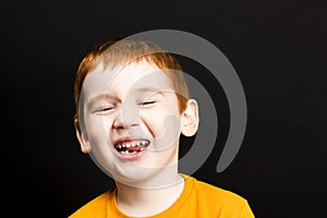 boy with red hair with a smile on his lips