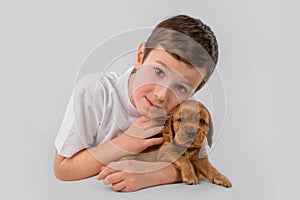 Boy with red puppy isolated on white background. Kid Pet Friendship