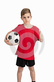 Boy in red shirt with soccer ball and thumb up