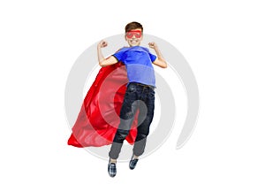 Boy in red super hero cape and mask flying on air
