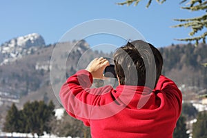 Boy in red sweater that he photographed the Summit of a mountain