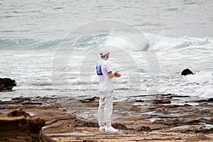 Boy reflecting while looking at the sea.