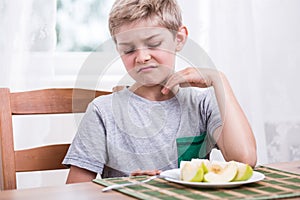 Boy refusing to eat apple