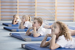 Boy relaxing on blue mat