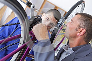 Boy repair bicycle wheel