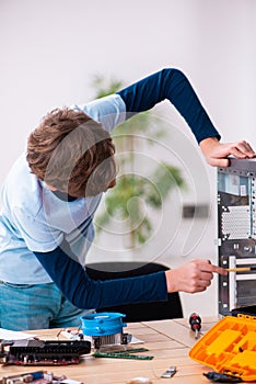 Boy reparing computers at workshop