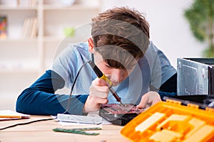 Boy reparing computers at workshop