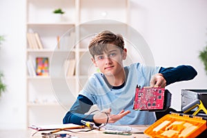 Boy reparing computers at workshop