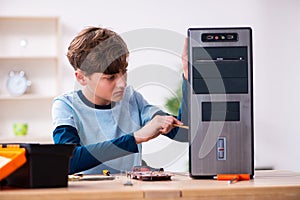 Boy reparing computers at workshop