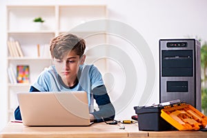 Boy reparing computers at workshop