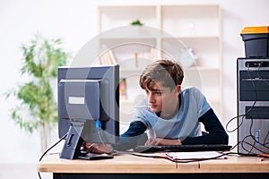 Boy reparing computers at workshop