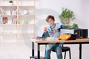 Boy reparing computers at workshop