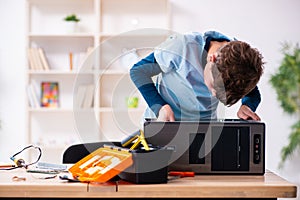 Boy reparing computers at workshop