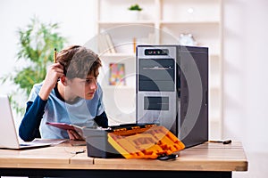 Boy reparing computers at workshop