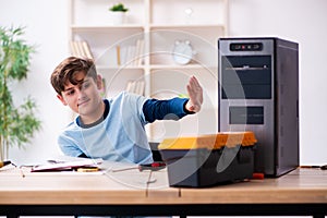 Boy reparing computers at workshop