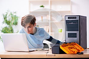 Boy reparing computers at workshop