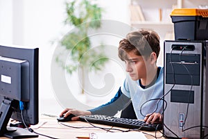 Boy reparing computers at workshop