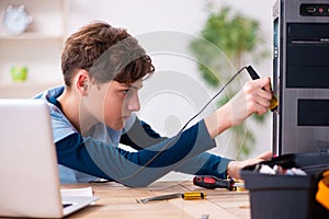 Boy reparing computers at workshop