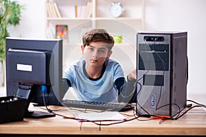 Boy reparing computers at workshop