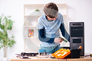 Boy reparing computers at workshop