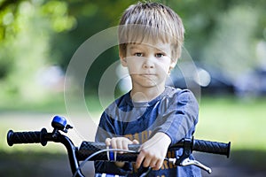 Boy ride a bicycle in city park