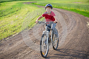 Boy ride on bike at rural road