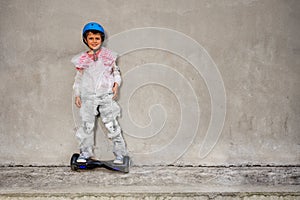 Boy ride hoverboard in overprotecting bubble wrap
