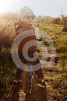 A boy rides a balance bike