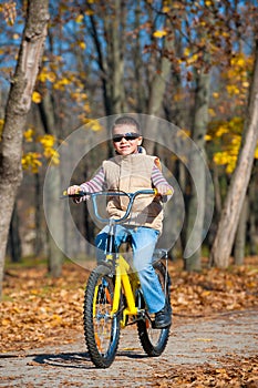 Boy rides a bicycle in park