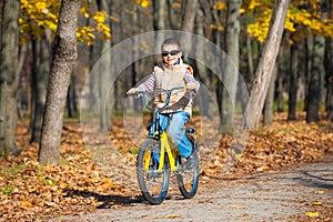 Boy rides a bicycle in park