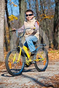 Boy rides a bicycle in park
