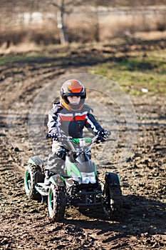 Boy rides on electric ATV quad.