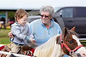 Boy Rides a Pony at a Fair