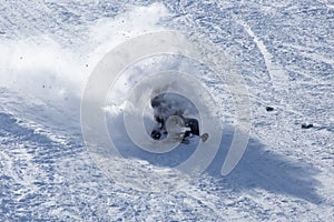 The boy rides a sled from the mountain in winter