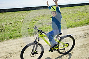 Boy riding the bike. Happy childhood moments. On sport. Active life in summer.