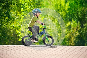 Boy riding bike in a helmet photo