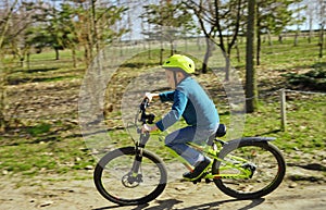 Boy riding bike near the forest. Travelling background. Summer outdoor activity. Healthy lifestyle.