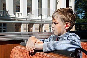 Boy riding on bus listening excursion