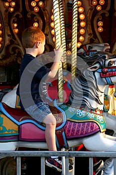 Boy Riding on Carousel