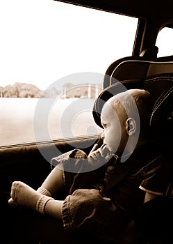 Boy riding in carseat photo