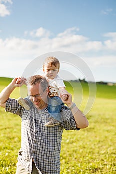 Boy riding his father's shoulders