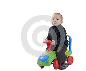 Boy riding his toy car